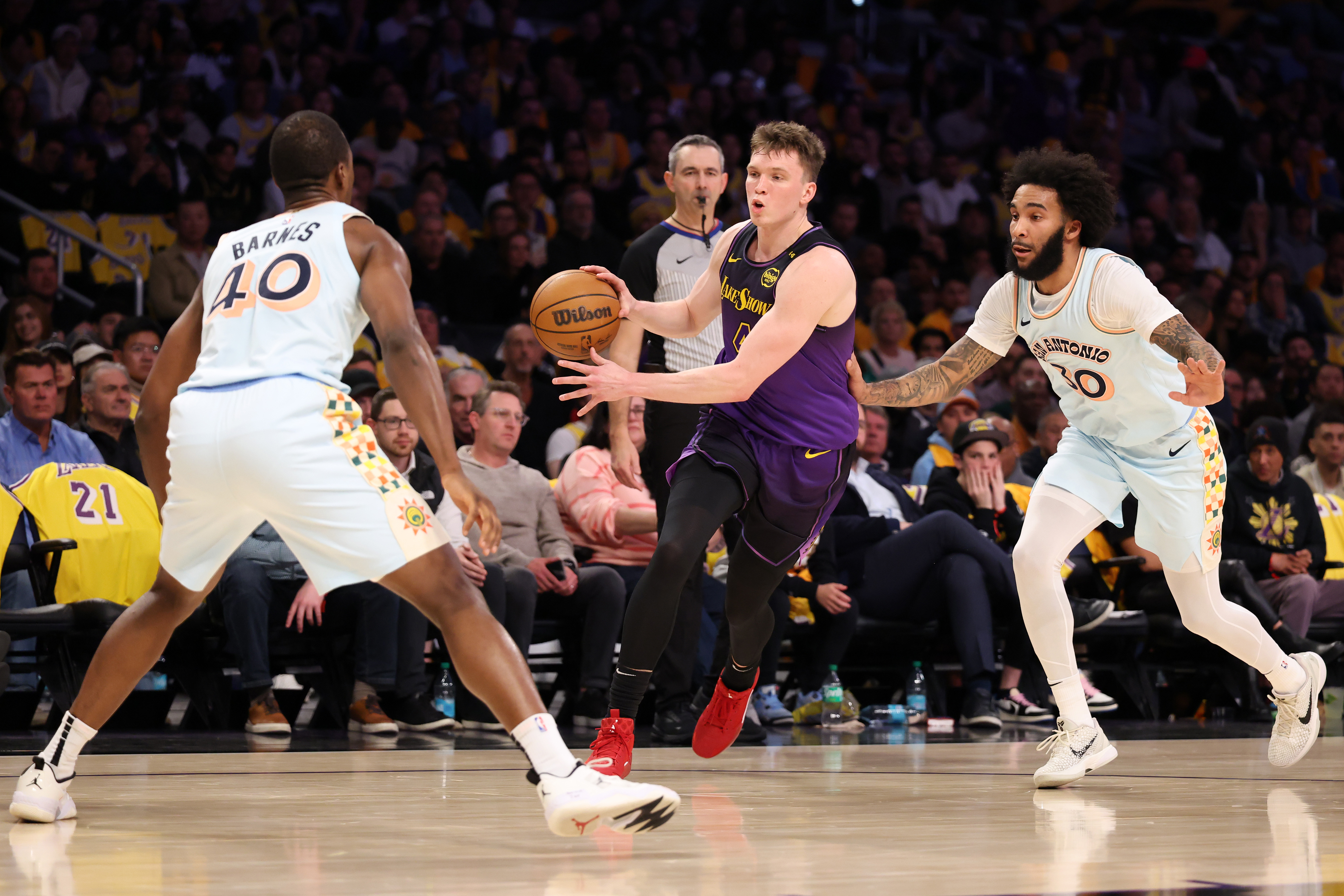 San Antonio Spurs forwards Julian Champagnie and Harrison Barnes defend Los Angeles Lakers forward Dalton Knecht