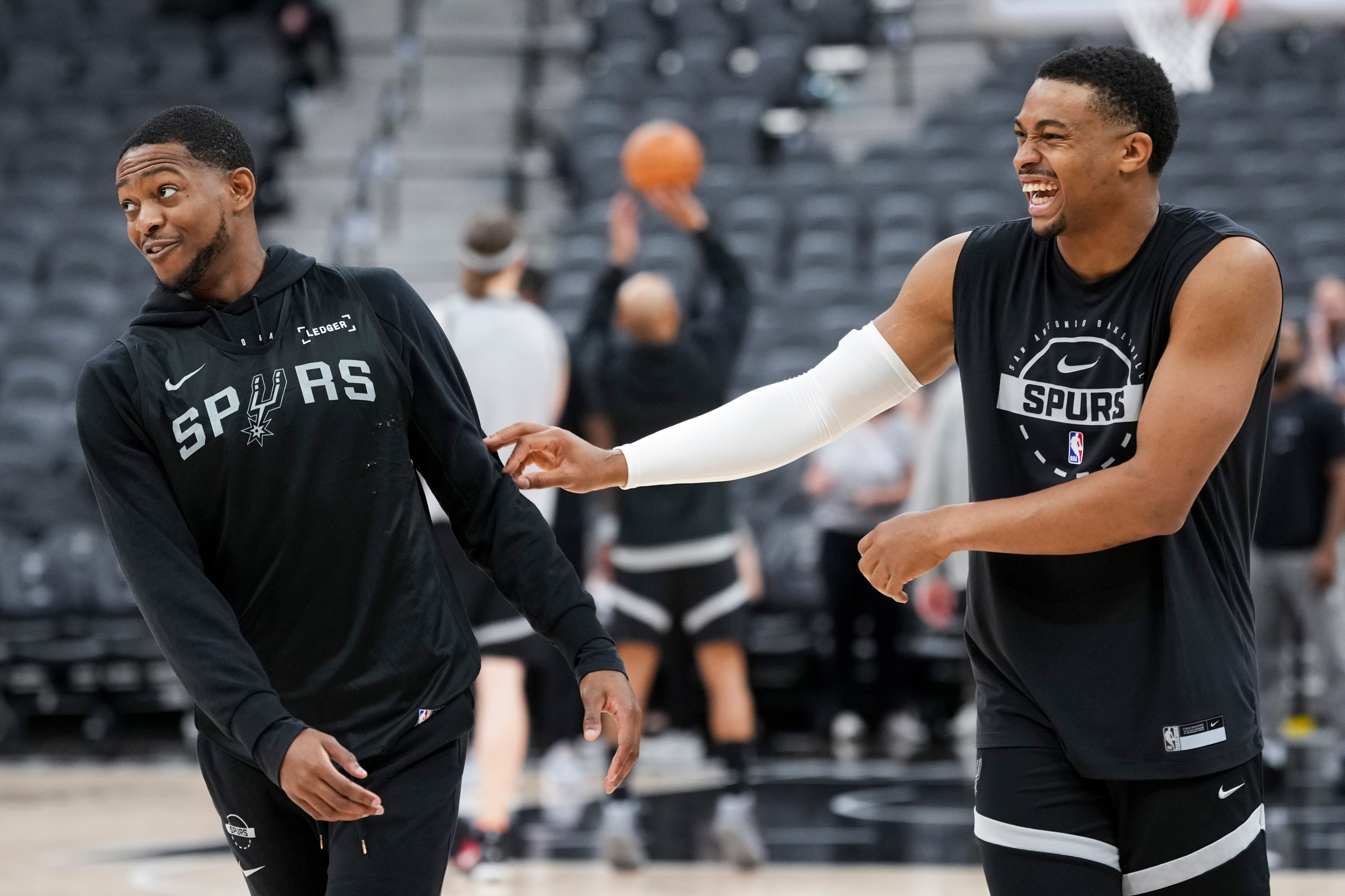 San Antonio Spurs guard De'aaron Fox, left, and forward Keldon Johnson laugh during a workout prior to the start of the NBA Finals basketball series against the New York Knicks, Tuesday, June 2, 2026, in San Antonio. (AP Photo/Eric Gay)