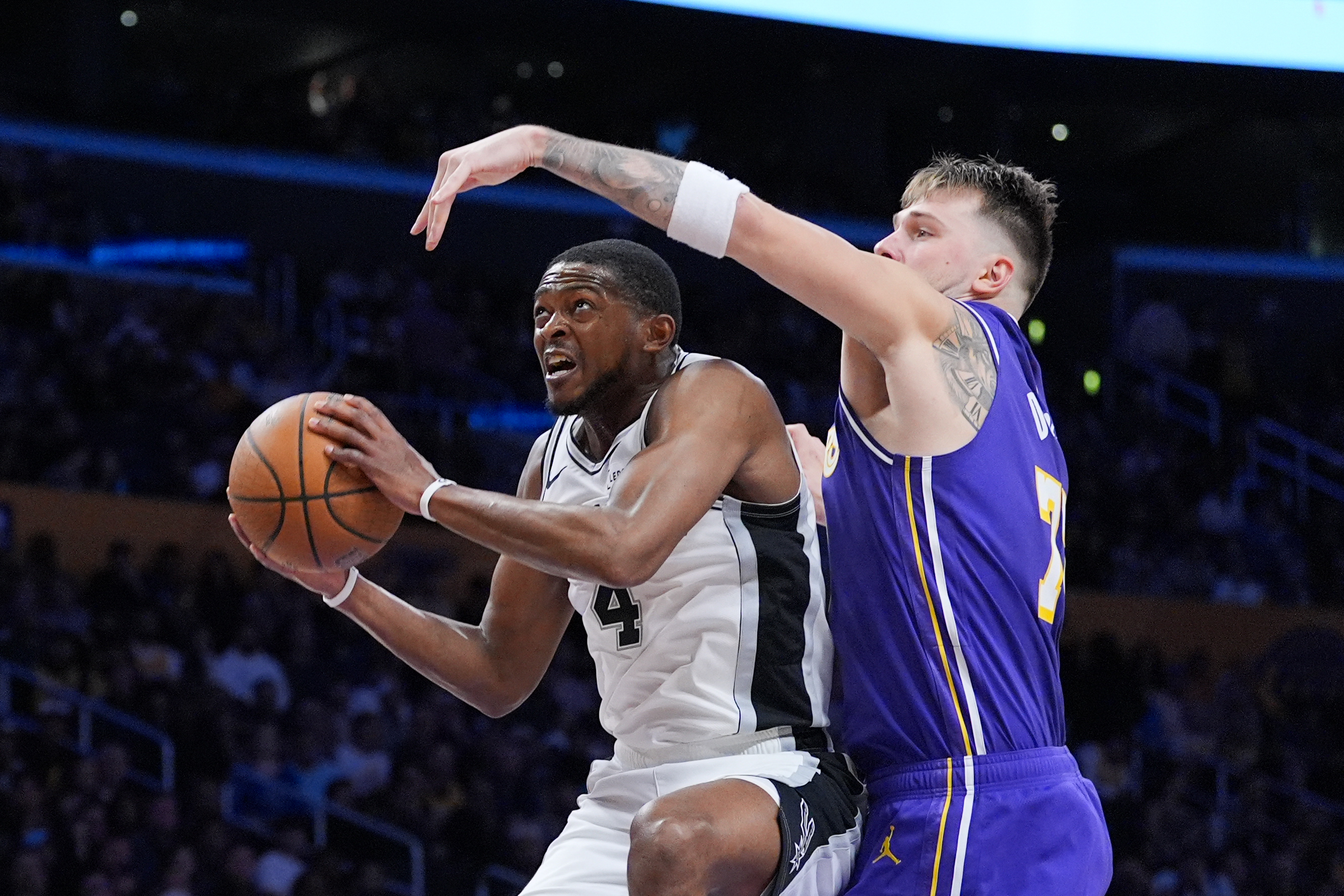 Los Angeles Lakers guard Luka Doncic (77) pressures San Antonio Spurs guard De'Aaron Fox (4) during the second half of an NBA Cup basketball game Wednesday, Dec. 10, 2025, in Los Angeles. (AP Photo/Jae C. Hong)