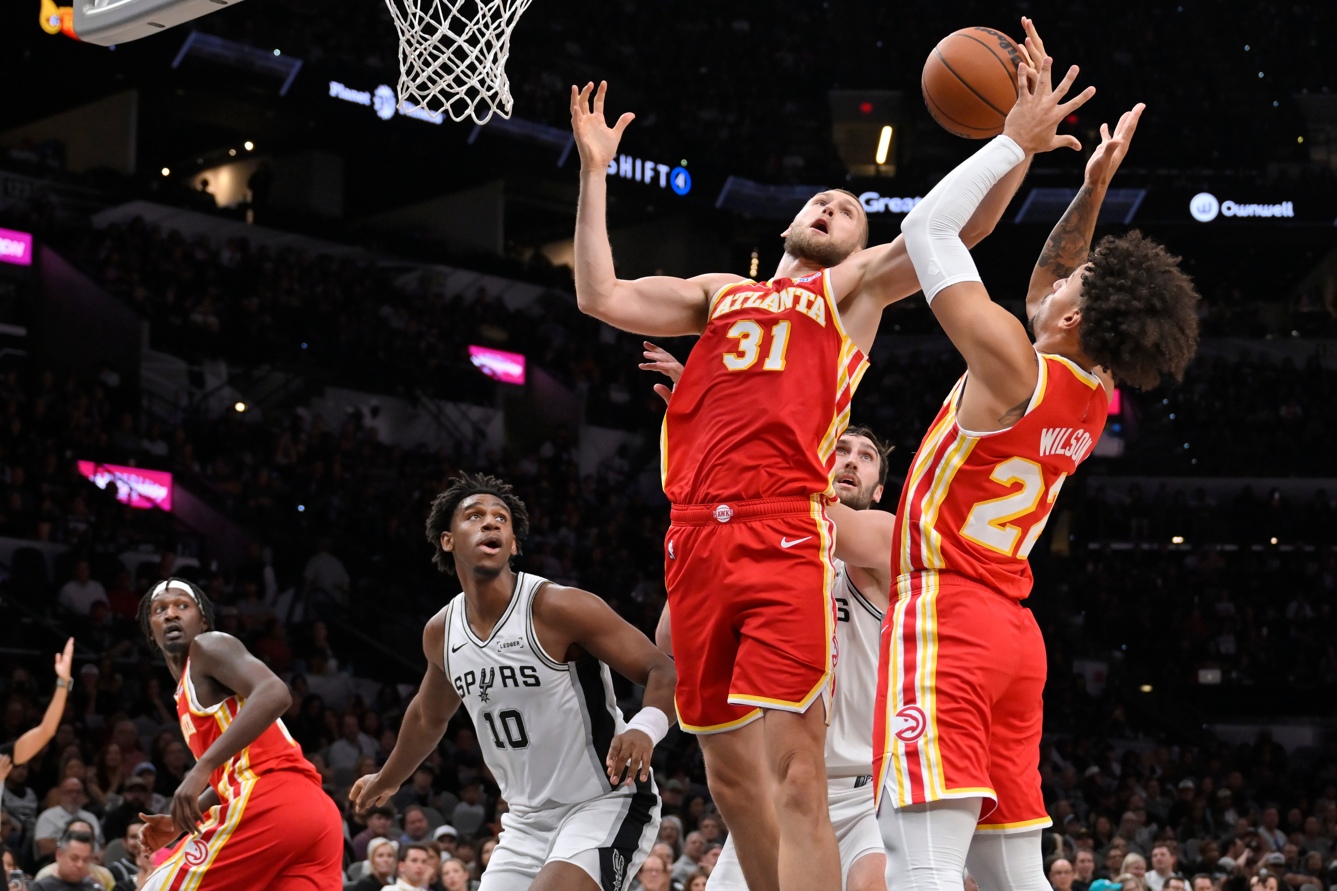Atlanta Hawks center Jock Landale (31) reaches for a rebound during the second half of a preseason NBA basketball game against the San Antonio Spurs, Thursday, Oct. 8, 2026, in San Antonio. (AP Photo/Darren Abate)